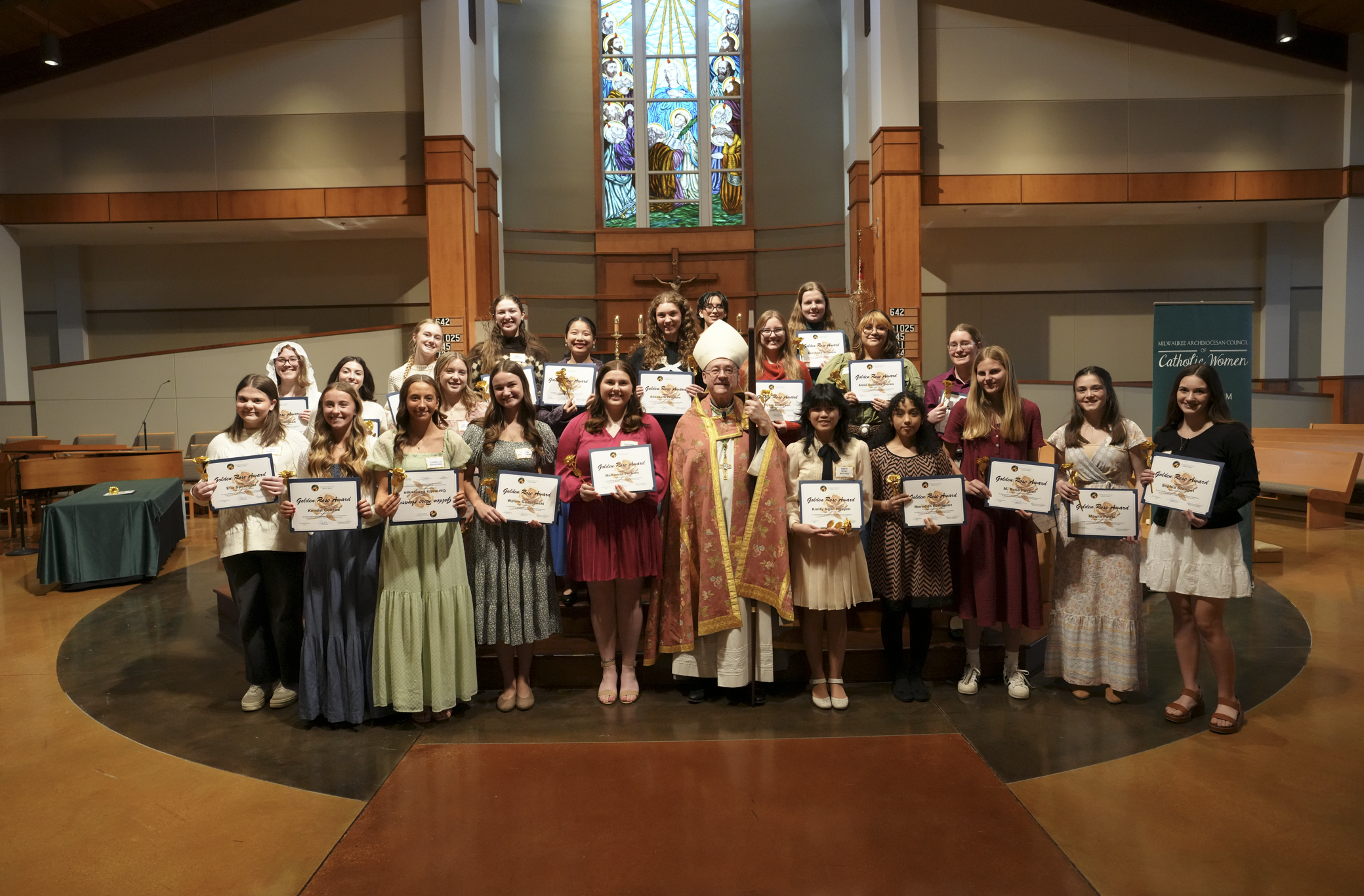 2026 Golden Rose Award recipients holding certificates in a church setting